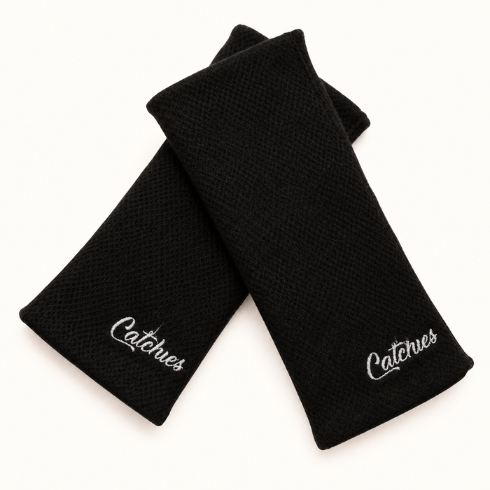 black Catchies wristbands crossed on ivory background