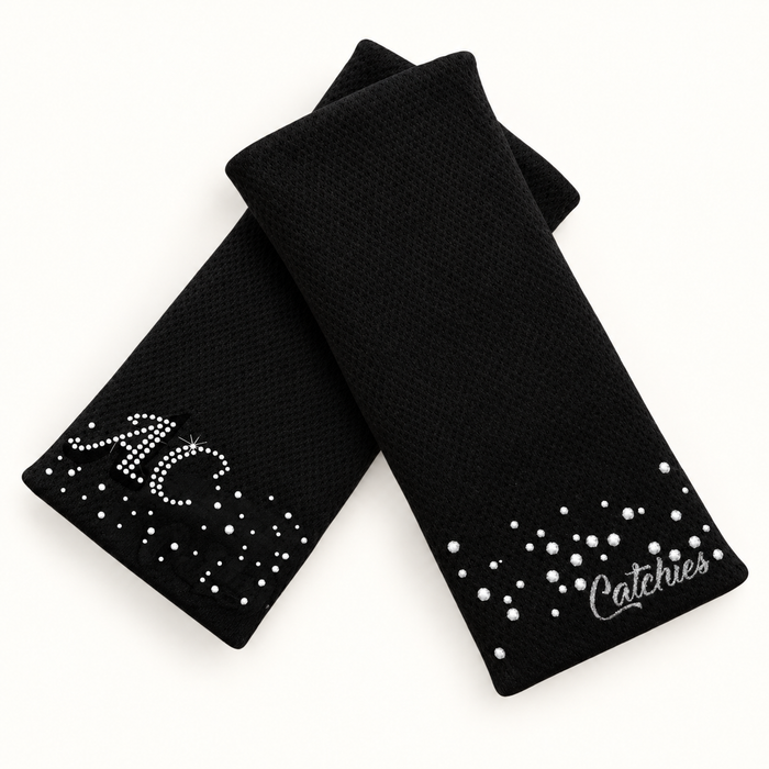 Initial Catchies Duo wristbands in crossed arrangement on ivory background