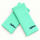 Minty Fresh Catchies wristbands in crossed arrangement on ivory background