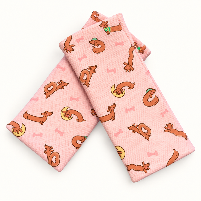 Double Back Dachshunds wristbands in crossed arrangement on ivory background