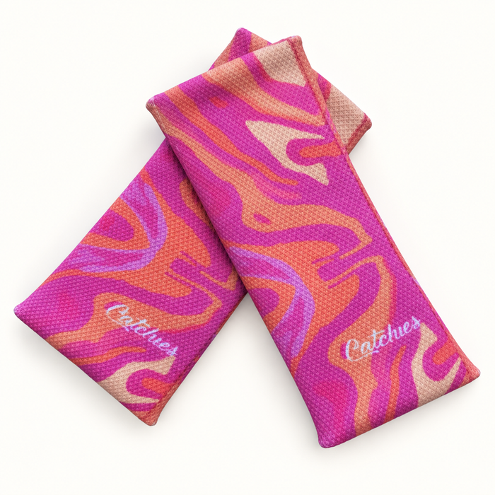 Orange Amplitude wristbands in crossed arrangement on ivory background