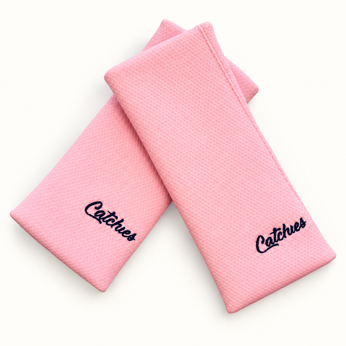 Perfect 10 Pink Solid Catchies wristbands in crossed arrangement on ivory background