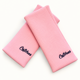 Perfect 10 Pink Solid Catchies wristbands in crossed arrangement on ivory background