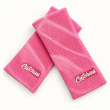 Pink Addiction Catchies wristbands in crossed arrangement on ivory background