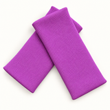 Pretty Purple wristbands in crossed arrangement on ivory background
