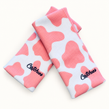 strawberry-cow Catchies wristbands crossed on ivory background