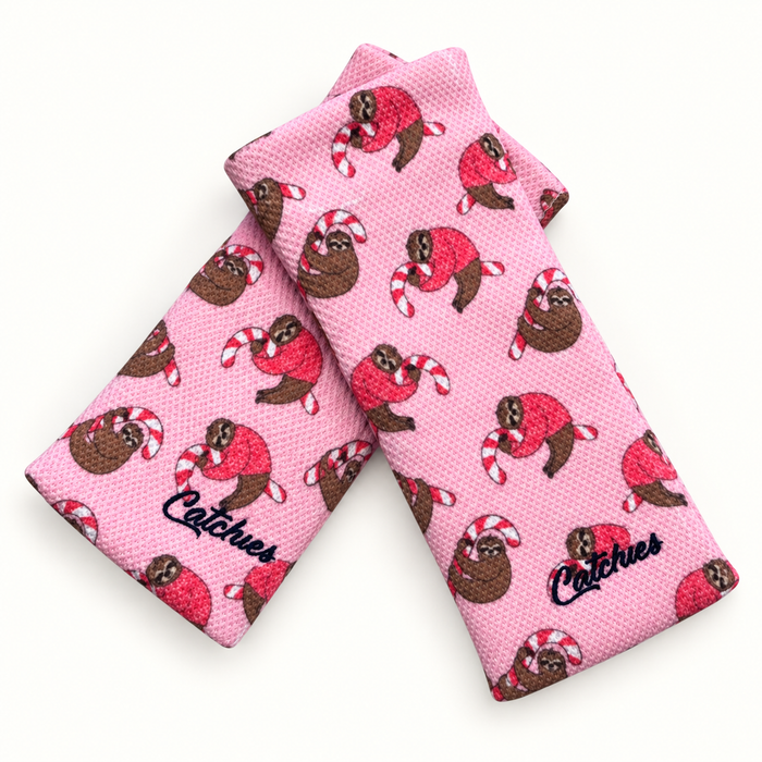 Sugar Sloth Catchies wristbands in crossed arrangement on ivory background