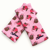 Sugar Sloth Catchies wristbands in crossed arrangement on ivory background