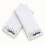 White Competition Catchies wristbands in crossed arrangement on ivory background