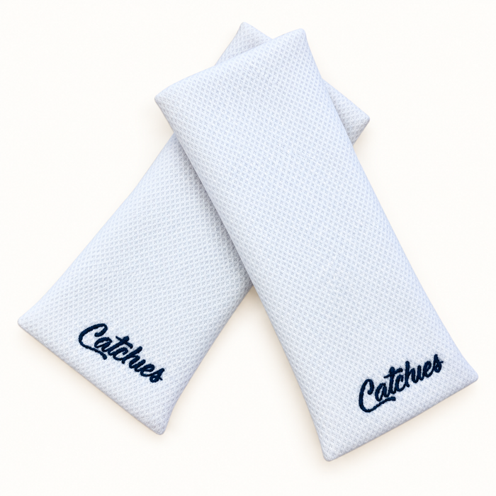 white Catchies wristbands crossed on ivory background